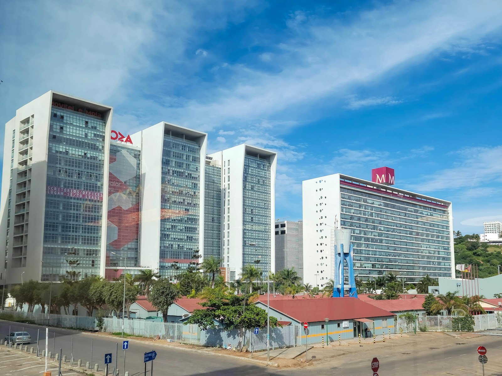 a group of tall office buildings with commercial property insurance sitting next to each other